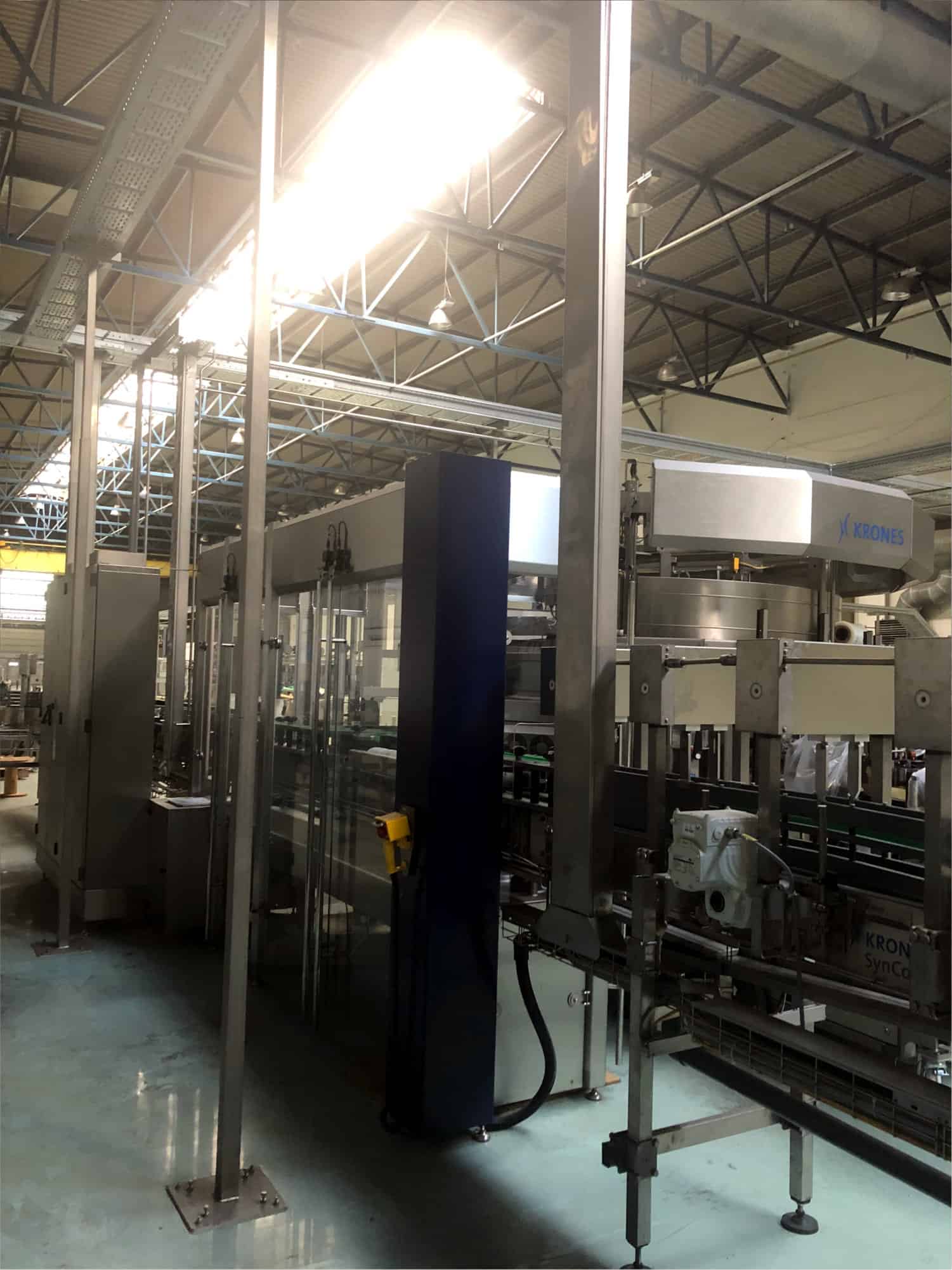 Back view of Krones one-way glass line